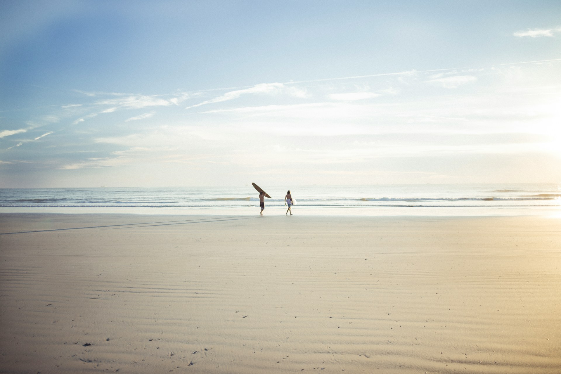 Surfers entering the water